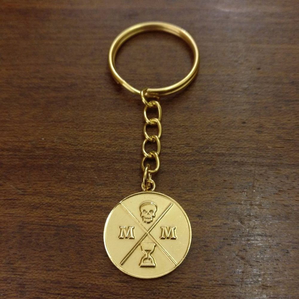 memento-mori-logo-gold-keyring-front